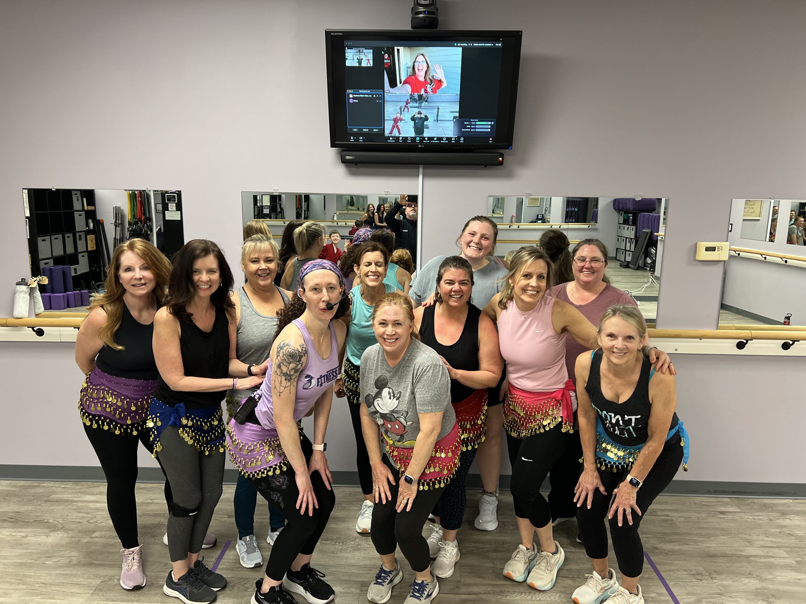 Group photo of Fitness Loon class participants with virtual Zoom members shown on screen