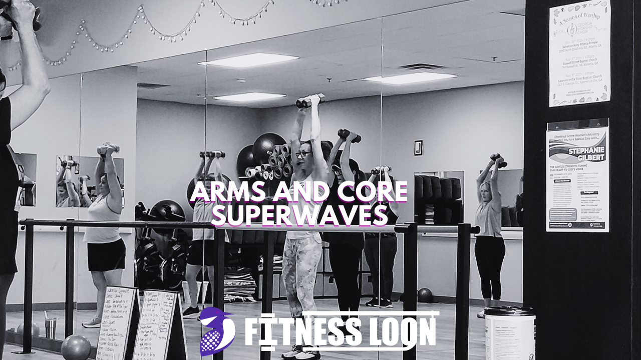 Fitness class lifting dumbbells in mirrored studio